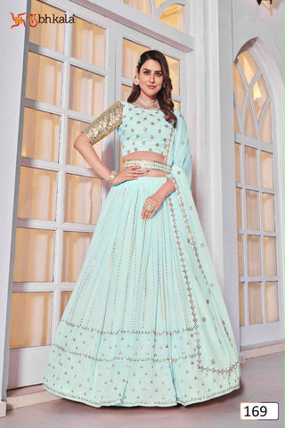 Model wearing a light aqua lehenga choli with gold-toned sequins and embroidery and matching dupatta